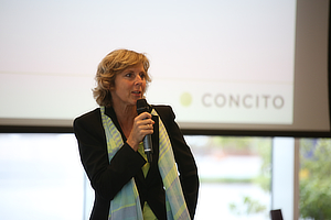 Connie Hedegaard speaking in front of a Concito logo